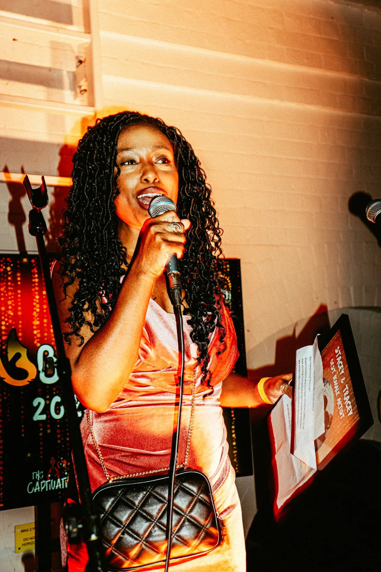 Vocalist performing with a handheld microphone at CEL3BRATION 2025